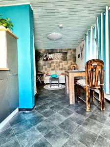 a kitchen with blue walls and a table and chairs at Casa Alba in Mastershausen +15 photos