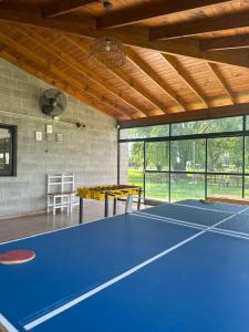 a tennis court with two ping pong tables at moraycamp in San Andrés de Giles