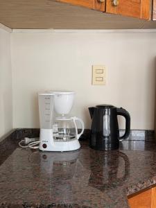 a kitchen counter with a blender on a counter top at Departamento Torre IV in Comodoro Rivadavia