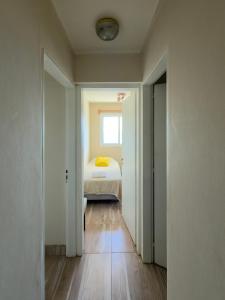 a small bedroom with a bed and a window at Departamento Torre IV in Comodoro Rivadavia +6 photos