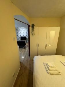 a bedroom with a bed and a living room at Tranquil 1BD in Edmonton in Ponders End