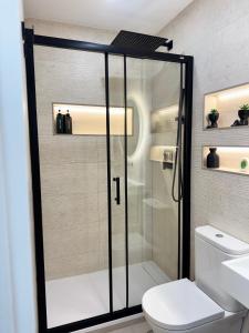 a bathroom with a shower with a toilet and a sink at Ap Fuenlabrada in Fuenlabrada
