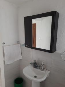 a bathroom with a sink and a mirror at Posada San Jorge in Pacho +22 photos