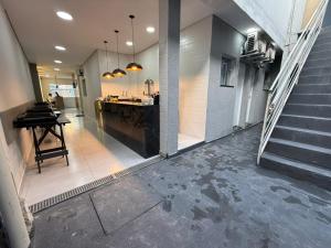 a hallway with a kitchen and a table in a building at Pousada Maranata in Aparecida +36 photos