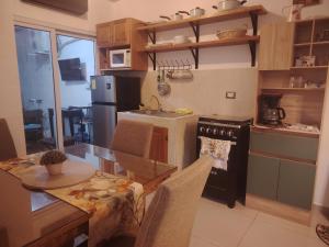 a kitchen with a table and a dining room at Casa Socorrito in Ahuachapán
