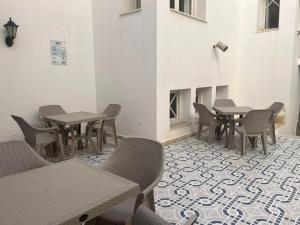 a room with tables and chairs on a tile floor at Hotel Mezri in Monastir