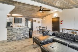 a living room with a leather couch and a bar at 1 Mi to Main St Eats! Single-Level Red Bluff Home in Red Bluff