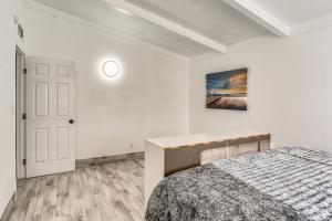 a bedroom with a bed and a painting on the wall at 1 Mi to Main St Eats! Single-Level Red Bluff Home in Red Bluff