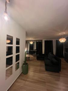 a living room with a couch and a table at Bega's BDuplex in Golem, Durrës in Golem