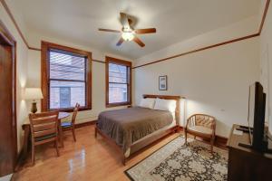 a bedroom with a bed and a desk and a ceiling fan at Epic Silver Valley Basecamp: Steps to Dtwn Fun! in Wallace