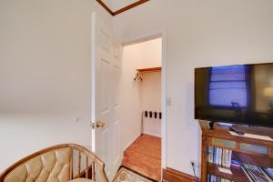 a living room with a flat screen tv next to a door at Epic Silver Valley Basecamp: Steps to Dtwn Fun! in Wallace