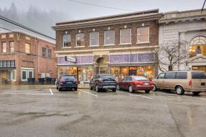 a parking lot with cars parked in front of a building at Epic Silver Valley Basecamp: Steps to Dtwn Fun! in Wallace