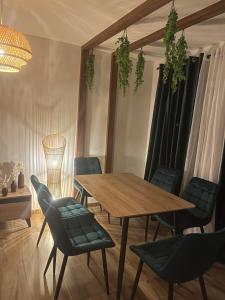 a dining room with a wooden table and chairs at Bega's BDuplex in Golem, Durrës in Golem