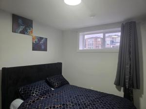 a bedroom with a bed and a window at YYC Cozy Suites in Calgary