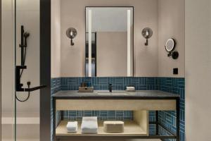 a bathroom with a sink and a mirror at Four Points by Sheraton Hefei High-Tech Zone in Hefei +14 photos