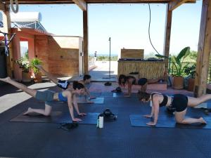 a group of women doing yoga in a room at Casa Toro La Punta in Puerto Escondido