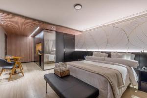 a bedroom with a large bed and a desk at Sia Park Executive Hotel in Brasília +22 photos