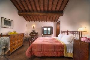 a bedroom with a large bed and a dresser at Terre di Nano in Monticchiello +65 photos