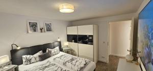 a bedroom with a bed with a black headboard at Ferienapartment Wilma in Grünsfeld +58 photos