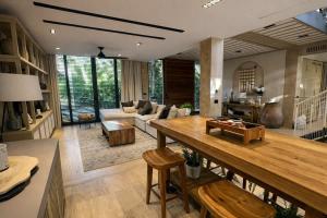 a living room with a table and a couch at Luxury Villa in Corasol 4BR Private Pool in Playa del Carmen