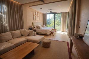 a living room with a couch and a bed at Luxury Villa in Corasol 4BR Private Pool in Playa del Carmen