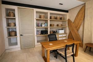 a dining room with a table and chairs and a book shelf at Luxury Villa in Corasol 4BR Private Pool in Playa del Carmen +16 photos