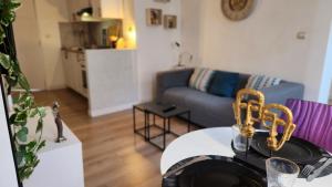 a living room with a couch and a table at Tribunal du Beffroi in Douai