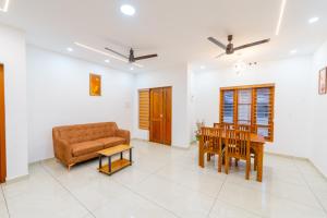 a living room with a couch and a table at Greenview Royal Stay Near Amrita Hospital Edappally in Cochin