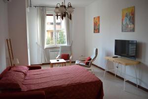 a bedroom with a bed and a flat screen tv at Cologno Centro Apartment in Cologno Monzese