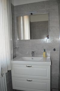 a bathroom with a white sink and a mirror at Cologno Centro Apartment in Cologno Monzese +17 photos