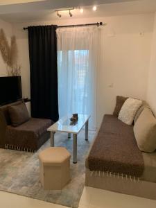 a living room with a couch and a table at Aura in Kumanovo