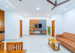 a living room with a couch and a tv at Greenview Royal Stay Near Amrita Hospital Edappally in Cochin