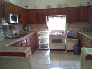 a kitchen with a stove and a sink and a refrigerator at Reach For The Islands in Corn Islands