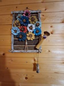 a bunch of flowers hanging on a wall at Cottage Mida in Mestia +10 photos