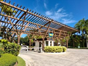 a pavilion with a wooden structure in a park at Beachfront Portillo Residence in Las Terrenas