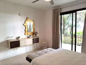 a bedroom with a large bed and a mirror at Beachfront Portillo Residence in Las Terrenas +43 photos