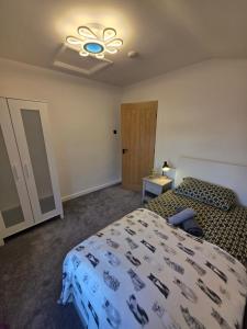 a bedroom with a bed and a ceiling fan at Magic Stays! in Halton