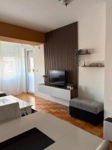 a living room with a couch and a television at Dolce Casa E K in Strumica