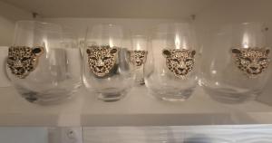 a group of glass vases with leopard handles on a shelf at Jungle Duplex with pool 5 min Disneyland in Serris