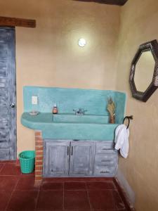 a bathroom with a blue sink and a mirror at Eco ITZKA Bernal Country House in Bernal +15 photos