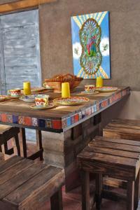 a wooden table with plates of food on top at Eco ITZKA Bernal Country House in Bernal