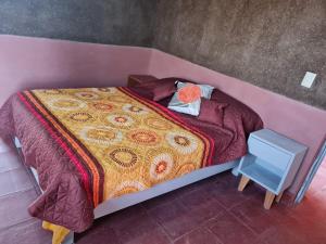 a bedroom with a bed with a pink wall at Eco ITZKA Bernal Country House in Bernal