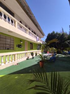 a courtyard of a building with a table and chairs at Nawal Hostel in Santa Cruz La Laguna