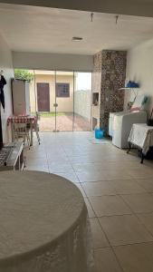 a large living room with a table and a kitchen at Casa do Igra in Torres