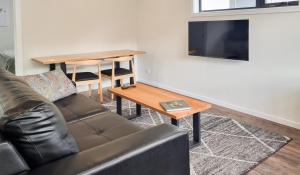 a living room with a couch and a table at Mt Field Retreat in National Park