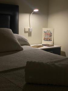 a bedroom with a bed and a lamp on a table at CASA do CAMPO Lestrove in Padrón