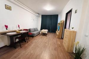 a living room with a couch and a table at Ho-Jack 2 - Apartment in Dudu +11 photos