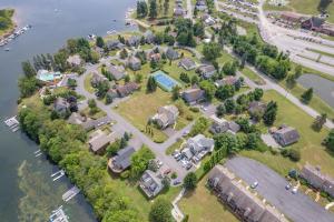 an aerial view of a subdivision of houses next to the water at Lake & Lift by Railey Vacations in McHenry