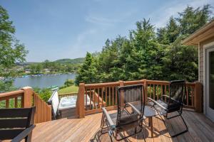 two chairs on a deck with a view of a river at Lake & Lift by Railey Vacations in McHenry