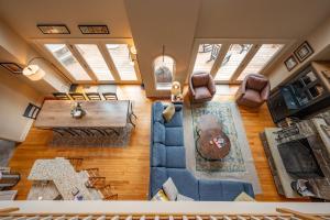 an overhead view of a living room with a couch and a table at Lake & Lift by Railey Vacations in McHenry +53 photos
